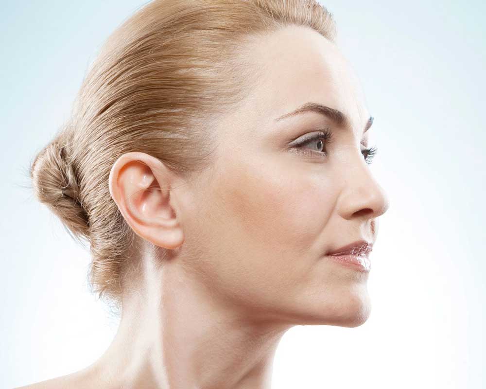 Beautiful older woman with hair pulled into bun